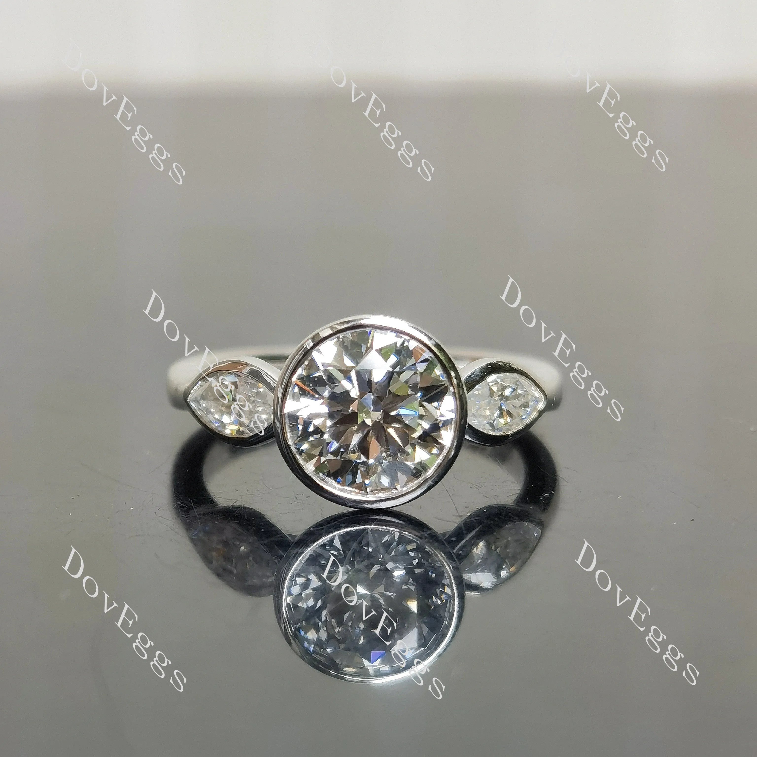 Angelina-Round bezel three stones moissanite engagement ring| DovEggs