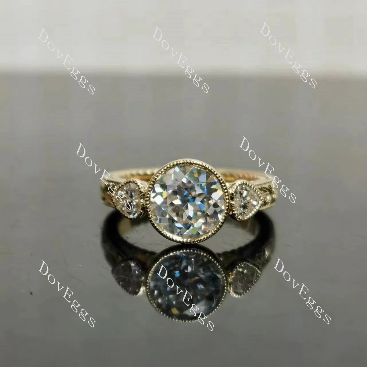Tin's'Ohana-Round bezel carved vintage three stones moissanite engagement ring| DovEggs