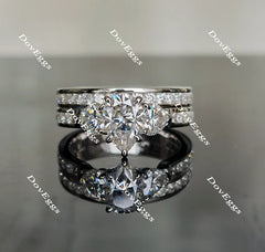 The Kiera Alaina pear half eternity channel set three stones moissanite engagement ring