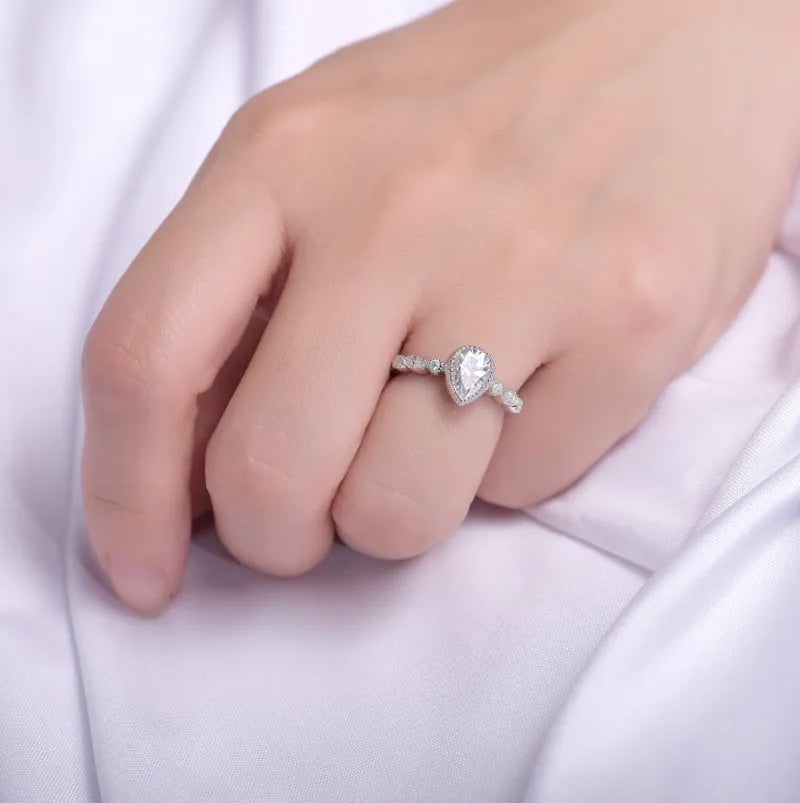 doveggs pear side stone moissanite engagement ring